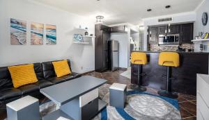 a living room with a couch and a kitchen at Galveston Condo With Resort Amenities - Sleeps 5 in Galveston