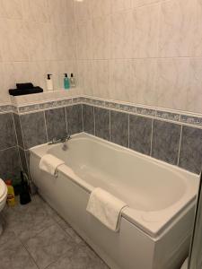 a white bath tub in a bathroom with a toilet at The Rossiter - City Centre Pad in Bath