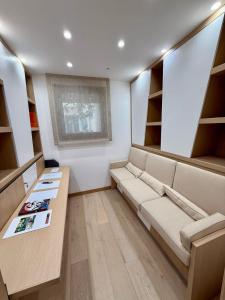 Cette chambre comprend un canapé, une table et des étagères. dans l'établissement Luxury Apartment in the heart of Principality of Monaco, à Monte-Carlo