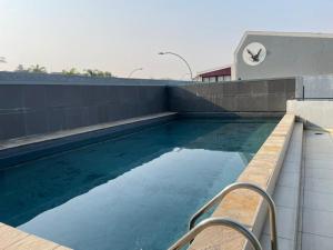 a swimming pool on the side of a building at Stylish Comfortable 2 bedroom apartment in the Heart of Windhoek in Windhoek