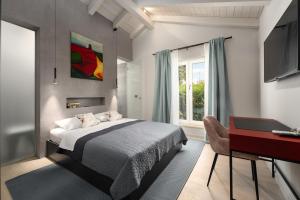 a bedroom with a bed and a desk and a window at Villa MaK a family Oasis with heated Pool & Nature Views in Sveti Lovreč Pazenatički +34 photos