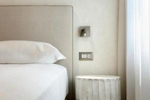 a bedroom with a bed and a clock on the wall at Primo Piano Rooms in Aversa