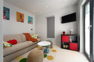 a living room with a couch and a table at Villa MaK a family Oasis with heated Pool & Nature Views in Sveti Lovreč Pazenatički