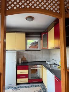 a kitchen with colorful cabinets and a sink at Apartment Green Heaven in Konjic