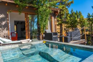 a swimming pool in front of a house at Bodega Linda in Puntagorda