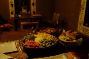 a table with two plates of food on a table at The dune camp in Mhamid +31 photos