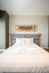 a bedroom with a bed with two towels on it at Star West Luxury in Belgrade