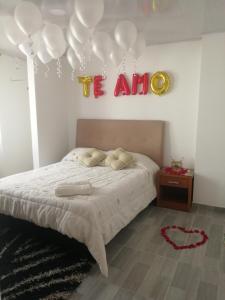 a bedroom with a bed with a sign that reads its autism at Casa Bercel in Choachí