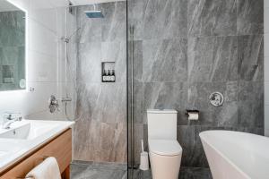 a bathroom with a shower and a toilet and a sink at The Powderhorn Chateau in Ohakune +40 photos