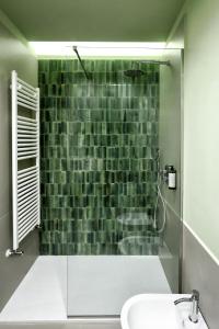 a bathroom with a glass shower with a sink at Primo Piano Rooms in Aversa +34 photos