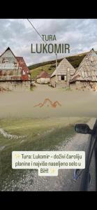 a picture of a village with a sign on the window of a car at Apartman AS na jezeru in Konjic
