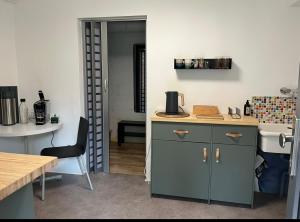a kitchen with a counter and a sink and a table at E11 Cologne in Cologne +1 photo