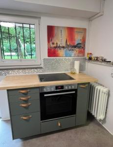 a kitchen with a stove and a counter top at E11 Cologne in Cologne
