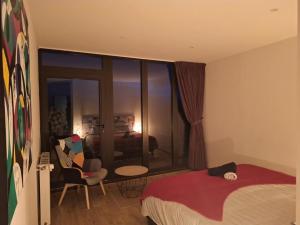 a bedroom with a bed and a living room at Les terrasses du golf in Égat