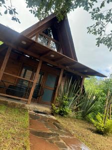 a house with a large window on the side of it at Cabañas el tigre in Mazamitla