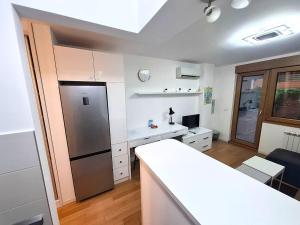 a kitchen with a refrigerator and a table in it at Apartment Tatiana in Belgrade