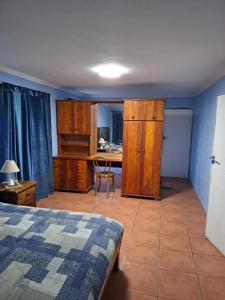 a bedroom with a bed and a desk and a table at 23 On Beach in Stompneusbaai +7 photos