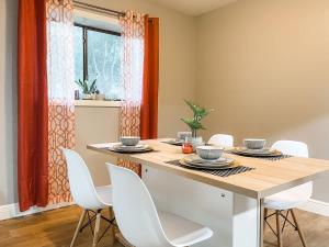 a dining room with a table and white chairs at Lovely 3 Bd 2 bath townhome in Perkins