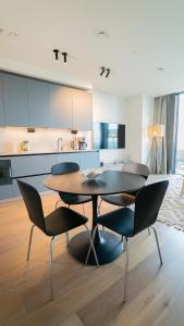 a kitchen with a table and chairs in a room at Karlatornet Sky Level in Gothenburg