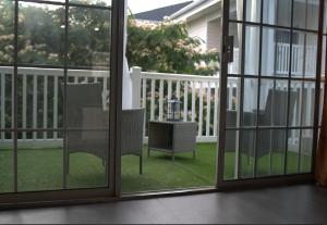 an open patio door with two chairs and a table at The Blue Oasis in Charlotte