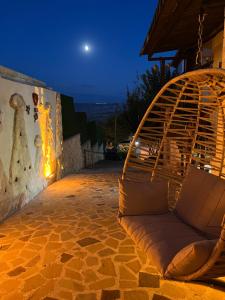 a couch sitting on a patio at night at Tatlı Kaya Cave Otel in Ürgüp