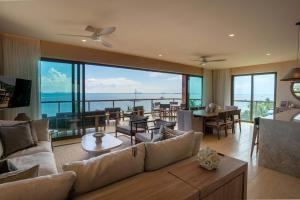a living room with a view of the ocean at Luxury Beachfront 4BR Apartment in Isla Mujeres in Isla Mujeres