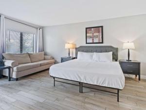 a bedroom with a large bed and a couch at JS Luxury Vacation in Orlando +31 photos