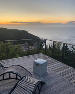 a wooden deck with a bench and a box at Myrto Homes Lefkada Agios Nikitas Greece in Agios Nikitas