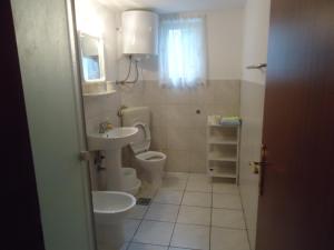 a bathroom with two toilets and a sink at Omiš apartment on the beach in Omiš