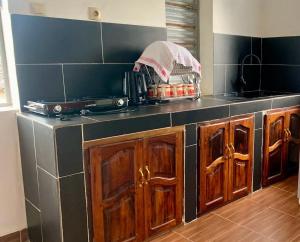 a kitchen with wooden cabinets and a counter top at Chez Pauline in Sainte Marie