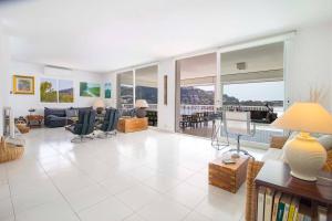 a living room with a couch and chairs and windows at Villa Sol y Mar by Mallorca Infinity in Madrid