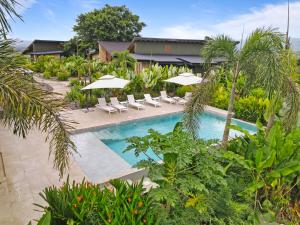 an image of a resort pool with chairs and umbrellas at Serene Hills in Fortuna
