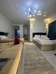 a bedroom with two beds and a stuffed teddy bear on the bed at king pyramids in Cairo