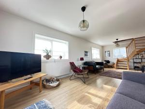 a living room with a large flat screen tv at Holiday Home in town Eyrarbakki South of Iceland - Birta Rentals in Eyrarbakki