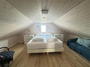 a bedroom with a bed in a attic at Holiday Home in town Eyrarbakki South of Iceland - Birta Rentals in Eyrarbakki