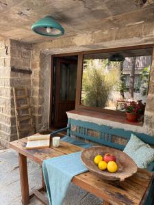 a wooden table with a bowl of fruit on it at Villa Filistrina in Yasna Polyana