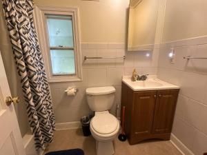 a bathroom with a toilet and a sink and a window at Prime Spot Staysimple Comfort, Perfect Location in Annapolis +16 photos