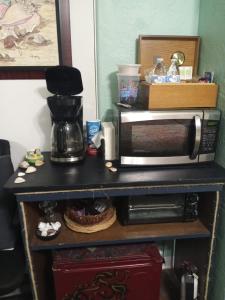 a counter with a coffee maker and a microwave at Tropical Hideaway in Daytona Beach +3 photos