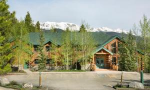 a log cabin with a parking lot in front of it at The Bivvi Hostel in Breckenridge