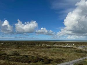 an aerial view of a field and the ocean at 6 person holiday home in Skagen in Skagen