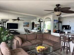 a living room with a couch and a table at Island Surf in Kihei