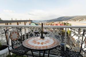 - une table avec deux verres de vin sur le balcon dans l'établissement Motel Mayfair on Cavell, à Hobart