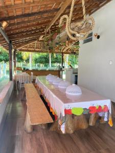 a long table with benches in a room at Casa de Praia em Joanes - Salvaterra in Joanes
