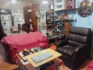 a living room with a couch and a table at Casa Solar da Lua COP30 in Belém