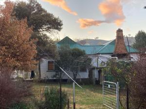 an old white house with a chimney at Lavender Cottage in Sofala +36 photos