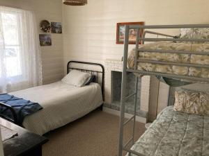 a bedroom with a bunk bed and a bunk bedouble at Lavender Cottage in Sofala