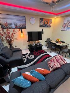 a living room with a couch and a table at CSL Apartments in Madina +62 photos