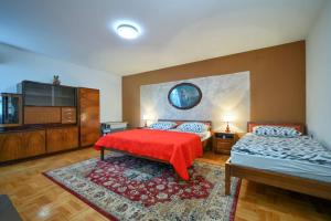 a bedroom with two beds and a flat screen tv at Family friendly house with a swimming pool Benkovec, Zagorje - 24902 in Bednja +10 photos
