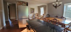 a kitchen and dining room with a table and chairs at River side Hunting Manor1869 in Waterville