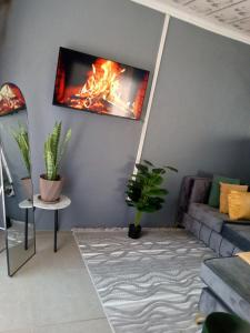 a living room with a fire on the wall at SinoVilla397 in Pretoria